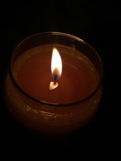 a candle that is lit in the dark