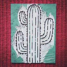 a piece of paper with a painting of a cactus on it's back side