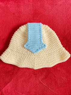 a crocheted cloth with a blue and white object sitting on top of it