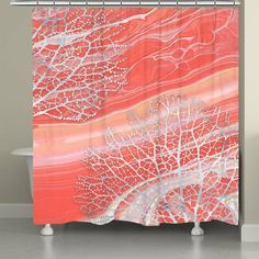 a shower curtain with red and white designs on the outside, in front of a bathtub