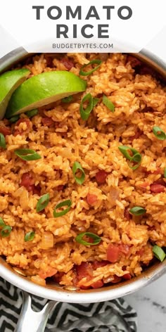 mexican rice with tomatoes and green onions in a pan on a marble counter top, with text overlay