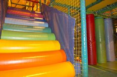 an indoor play area with colorful plastic tubes