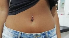 a woman's stomach with a tiny bead on the end of her belly