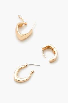 Set of high - polish hoop earrings featuring geometric designs and latch back, omega, and huggie closures. | Three pairs, six pieces total | Diameter: 0.5" | Geo Hoop Earring Set Hoop Earring Set, Hoop Earring Sets, Geometric Designs, Earring Set, Hoop Earrings, Design