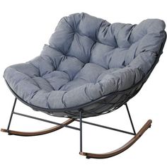 a rocking chair with a grey cushion on it's back and wooden legs, in front of a white background