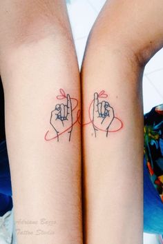 two people with matching tattoos on their arms