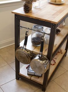 a kitchen island with pots and pans on it in front of a pine cone