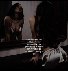 a woman looking at herself in the mirror with her hand on her hip and another person's reflection behind her