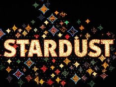 the words stardust are lit up in bright colors