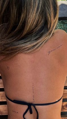 the back of a woman's neck with writing on it