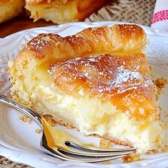 a close up of a piece of pie on a plate with a fork in it