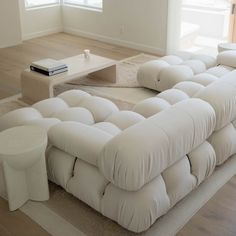 a large white couch sitting on top of a hard wood floor