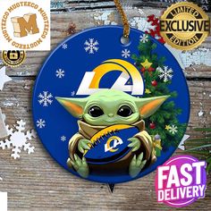 a christmas ornament with an image of baby yoda holding a football ball