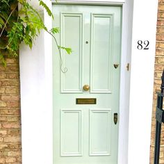 a green door is shown in front of a brick building