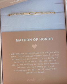 an open box with a necklace and card on it that says matron of honor