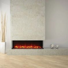 a modern fireplace in a living room with white walls and wood flooring on the side