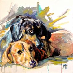 two dogs laying next to each other on top of a floor covered in spray paint