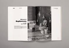 an open book with black and white photos on the pages, showing people standing outside