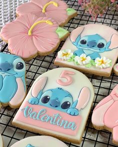 decorated cookies are on a cooling rack with flowers