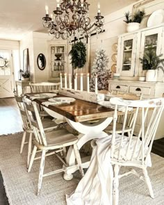 a dining room table with chairs and a chandelier