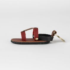 Step into style with the Chappal Mini Sandal Leather Keychain! This fun and quirky accessory is made from scrap buffalo leather, making it not only fashionable and fun, but also environmentally friendly. The assorted colors make it perfect for the fashion-forward, eco-conscious individual. This sandal keychain is a playful addition to any keyring. (Because who doesn't love a little footwear on their keys?) Leather Making, Buffalo Leather, Leather Keychain, Eco Conscious, Leather Sandals, Environmentally Friendly, Buffalo, Fashion Forward, Sandals