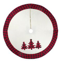 a red and black plaid christmas tree skirt hanging on a white circle with trees in the center