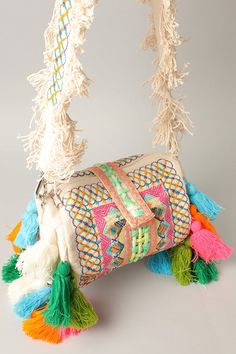 The Ibiza Pom Pom Bag adds style and sophistication to any look. This crossbody bag is exquisitely crafted with an embroiled knit and features an adorable pom pom adornment. Carry it as a clutch or use the crossbody strap for a hands-free option. This style is sold online only. Pom Pom Clutch, Bohemian Style Bag, Pom Pom Bag, Diy Straw, Boho Tote Bag, Tassel Decor, Bags Diy, Diy Bag Designs, Embellished Bags