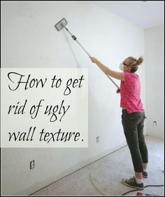 a woman in pink shirt painting wall with sprayer and white lettering that says how to get rid of ugly wall texture