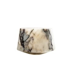 a white and black marble bowl sitting on top of a table