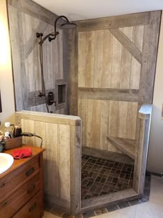 a bathroom with a wooden shower stall and tiled flooring, next to a sink