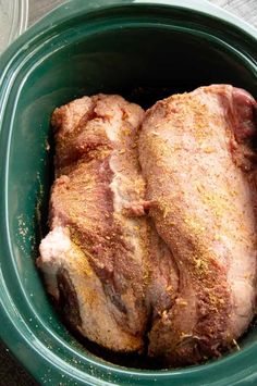 a close up of a meat in a bowl with seasoning on the inside of it