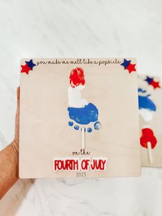 the fourth of july card is being held by someone