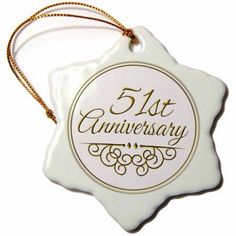 a white ornament with gold lettering on it that says,'4th anniversary '