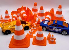 toy cars and traffic cones on a white surface