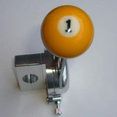 an orange door knob with a white ball on it's side and a black one in the middle