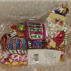 a plastic bag filled with assorted candy and santa clause figurines on top of a table