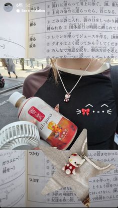 an image of a woman holding up her cell phone and wearing a cat t - shirt