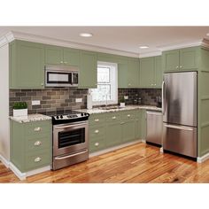 a kitchen with green cabinets, stainless steel appliances and wood floors is shown in this image