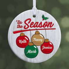 a wooden ornament with ornaments hanging from it's side and the words tis the season