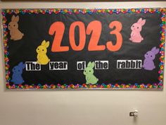 a bulletin board with the year of the rabbit written on it and colorful bunnies