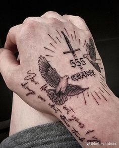 a person with a tattoo on their arm holding a cross and two doves in the background