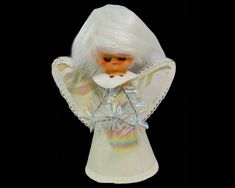 an angel doll with white hair wearing a white dress and holding a fan in her hand