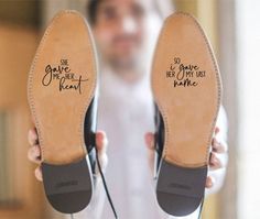 a man holding two pairs of shoes that say i love you from head to toe