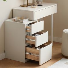 a white desk with drawers and a lamp