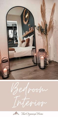 a bedroom mirror with candles on the floor and an image of a bed in the background