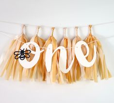 there are some tassels hanging from the clothes line with one word on it