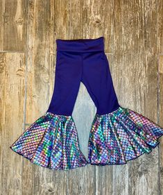 These leggings are Veteran made in the USA. Hand Sewn by a former Marine! Show some support by snatching up a pair of these show stopping bell bottoms! This Listing is for a pair of  Pair these with your favorite shirt to complete the look! 100% HANDMADE WITH HIGH QUALITY FABRIC SIZES 2T TO 6 WASH IN COLD WITH LIKE COLORS INSIDE OUT WASH ON GENTLE SETTING/DRY ON LOW HEAT OR DRY NATURALLY SIZE GUIDE: 2t Waist: 16" Inseam: 14" 3t Waist: 16.5" Inseam: 16" 4t Waist: 16.75" Inseam: 17" 5t Waist: 17.2 Stretch Purple Bottoms For Costume Party, Playful Blue Leggings, Playful Fitted Purple Bottoms, Playful Fitted Footless Pants, Stretch Blue Mermaid Bottoms, Blue Stretch Mermaid Bottoms, Diy Bell Bottoms, Kids Bell Bottoms, Toddler Bell Bottoms