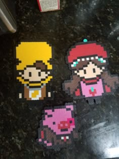 some pixel art stickers sitting on top of a table