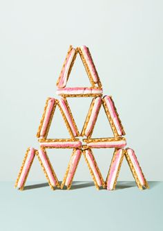 pink and white cookies stacked on top of each other in the shape of pyramids