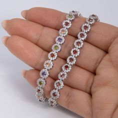 Round-Cut CZ Flower Tennis Bracelet Sterling Silver 925 * Metal : Real Sterling Silver (Properly Stamped, 925) * Condition : Brand New * Finish : Polished * Average Weight : 14.95 grams * Length : 7.25" * Width : 7mm = 1/4" * Clasp/Bail : Figure 8 Safety Clasp All of our items are brand new and are shipped with a gift box. Multicolor Round Sterling Silver Bracelet, Silver Multi-stone Flower Jewelry, Bracelet Tennis, Figure 8, Average Weight, Bracelet Sterling Silver, Tennis Bracelet, Chain Link Bracelet, Sterling Silber